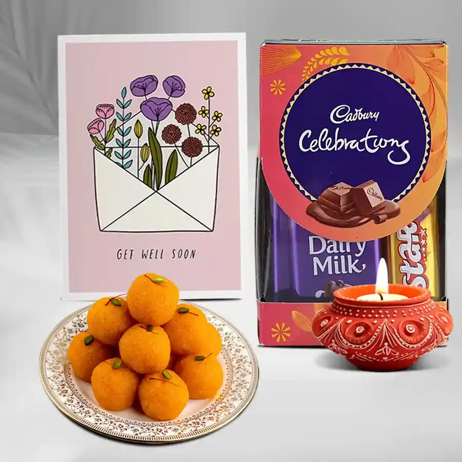 Diwali Essentials Hamper featuring a crafted Diya, Motichoor Laddu, Cadbury Celebrations Mini Pack, and a free message card.