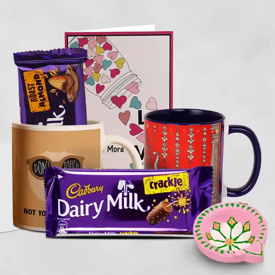 Message of Joy Diya and Chocolates hamper featuring a diya, two Cadbury Dairy Milk chocolates, and two printed coffee mugs with a personalized message card.