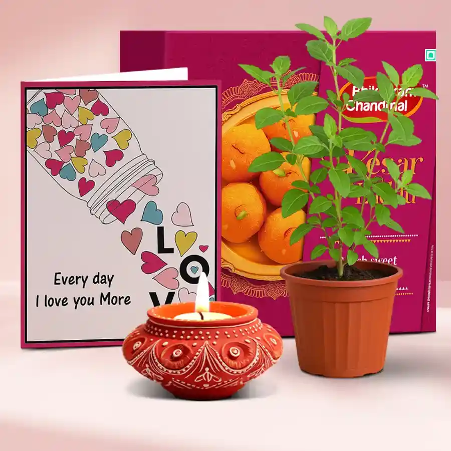 Festive hamper featuring a Diya, Kesar Laddu, and a pot of fresh Tulsi, perfect for Diwali celebrations.