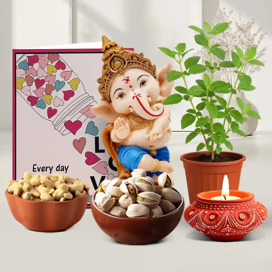 Ganesha and Sacred Greenery Gift Hamper for Diwali featuring a decorated Diya, premium almonds and pistachios, a Lord Ganesha showpiece, and a Tulsi plant