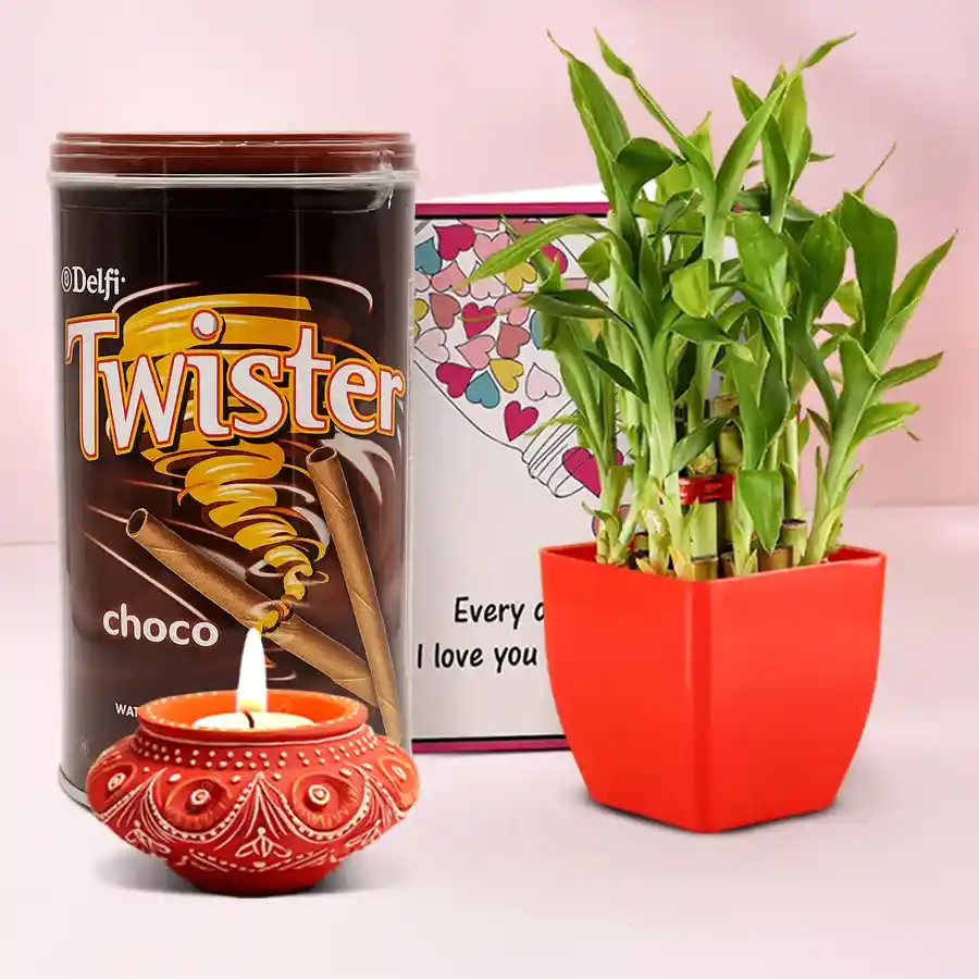 Diwali Delights and Green Blessings hamper featuring a decorative Diya, Twister Wafer Rolls, and a Three Tier Lucky Bamboo Plant, accompanied by a personalized message card.