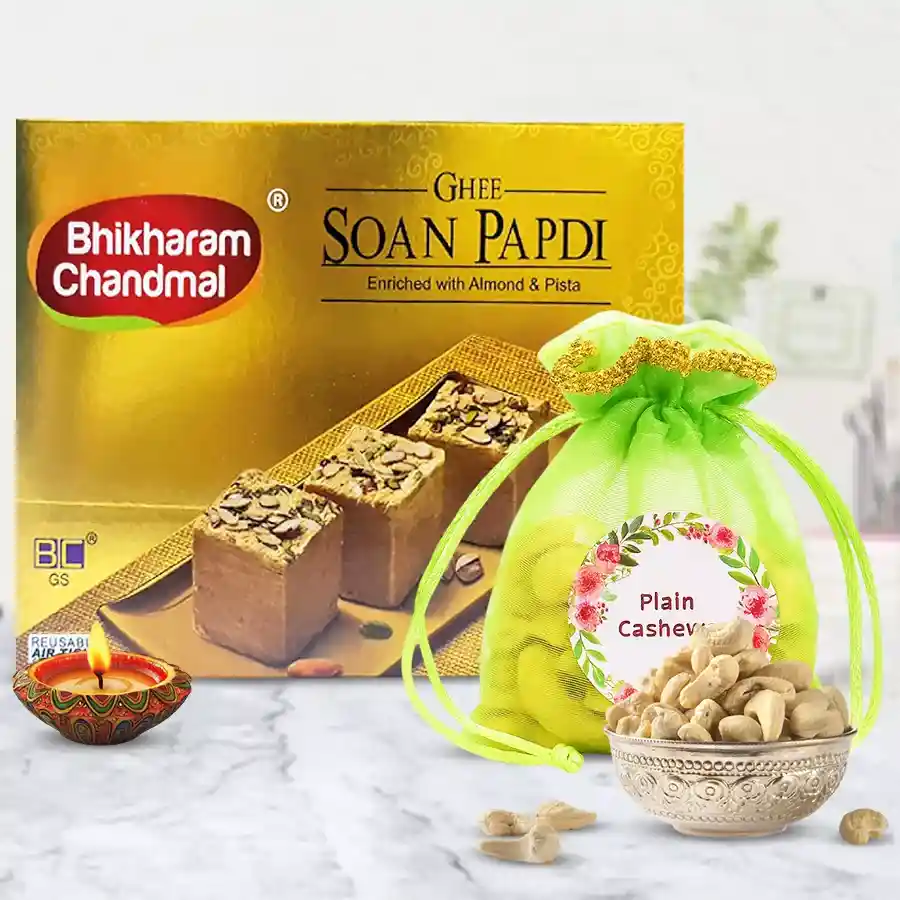 Cashews and festive diya hamper featuring a Diya, Ghee Soan Papri, and roasted cashews