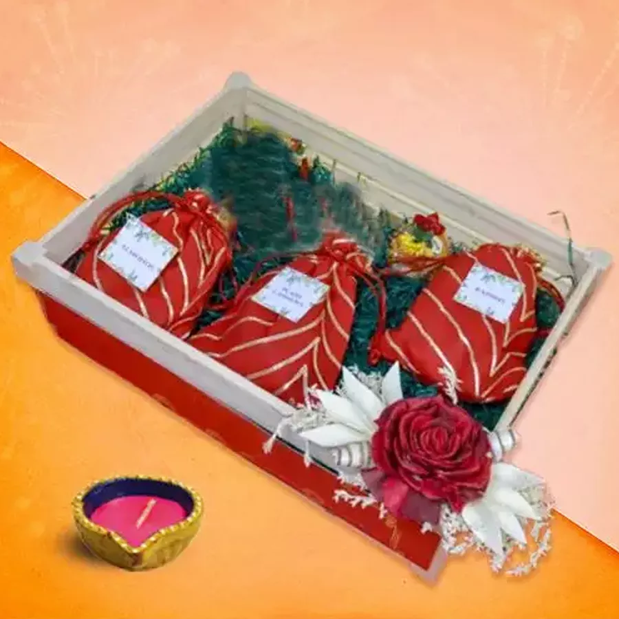 Diwali Wellness Nuts and Light Hamper featuring a Diya, premium plain cashews, almonds, and sweet raisins.