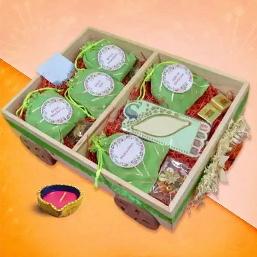 Diwali hamper filled with sweet dried fruits and crunchy nuts, including blueberries, kiwi, pineapple, pistachios, and almonds, accompanied by dry fruit mewa bites.