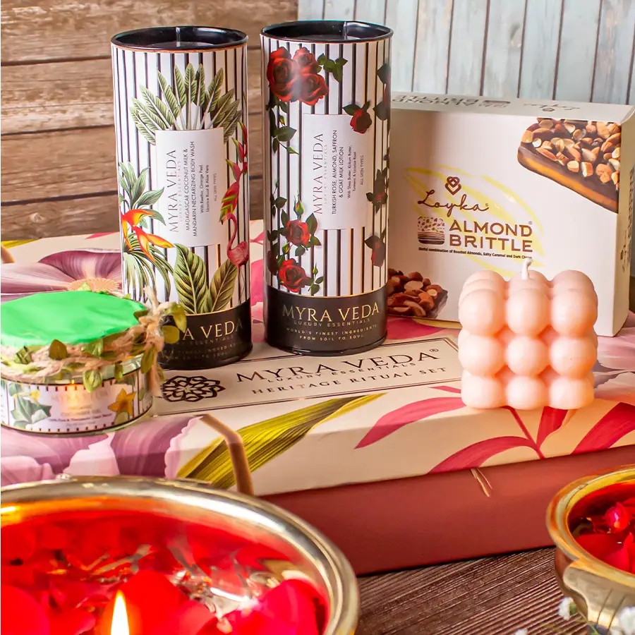 Decadent Delights Hamper featuring Almond Brittle Chocolate, Turkish Rose, Saffron & Goat Milk Lotion, Organic Face & Neck Gel, Madagascar Coconut Milk & Mandarin Body Wash, Organic Soya Wax Candle, and crunchy almonds