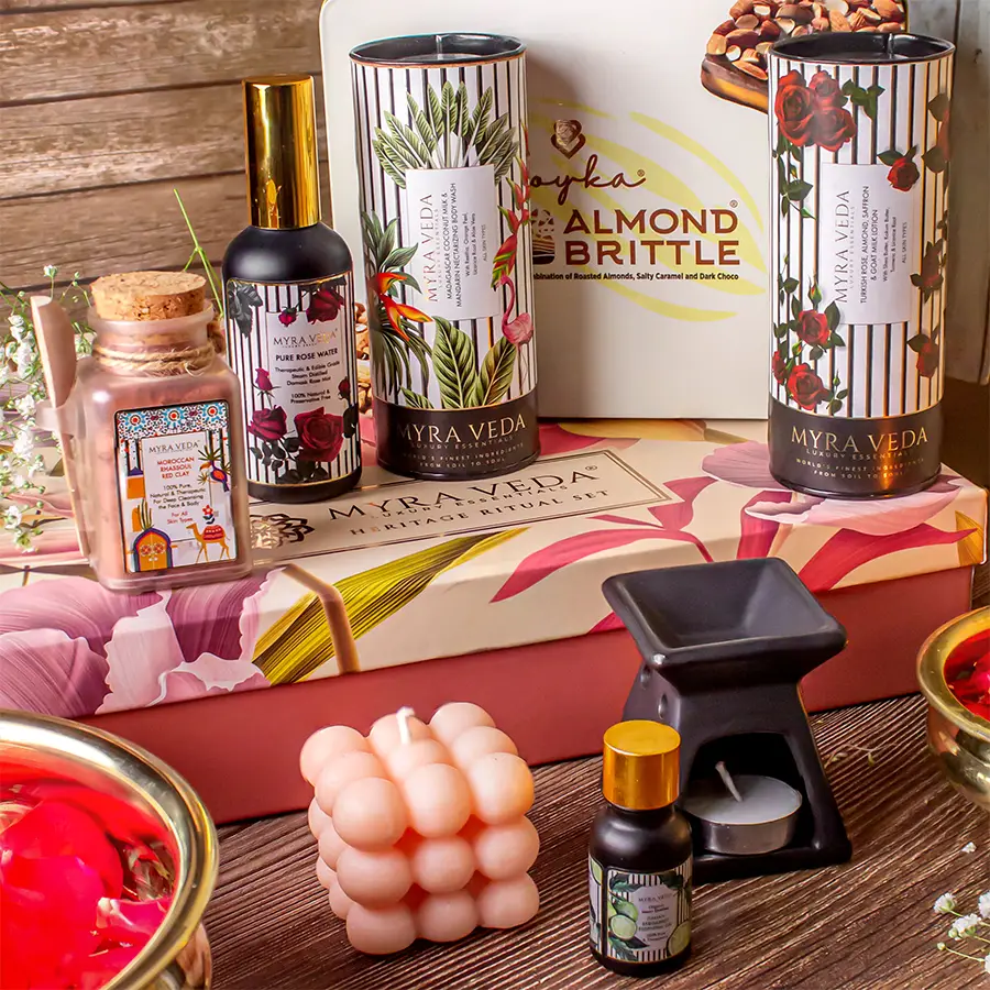 Nourish N Relaxing Gift Hamper featuring Almond Brittle Chocolate, Pure Rose Water, Madagascar Coconut Milk Body Wash, Organic Soya Wax Candle, Bergamot Essential Oil with diffuser, Turkish Rose Almond Saffron Goat Milk Lotion, Tea Light Candle, and Organic Clay.