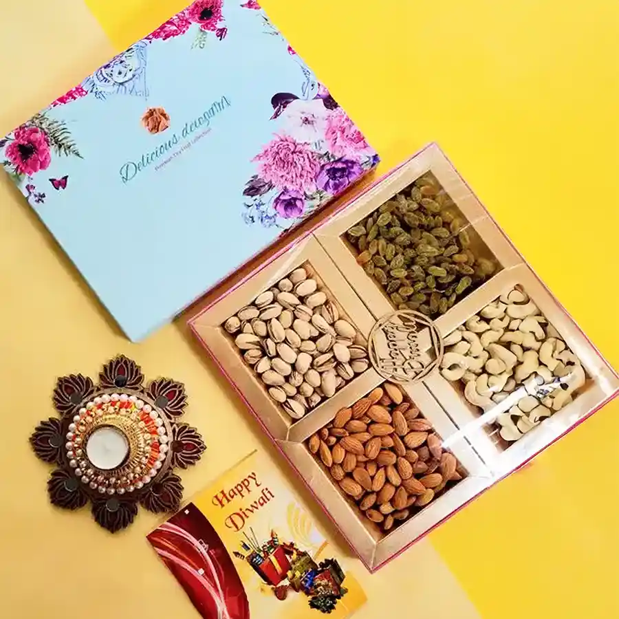 A beautifully arranged Diwali hamper featuring premium cashews, almonds, pistachios, and raisins, accompanied by a stylish T-light candle set, all presented in an elegant gift box.