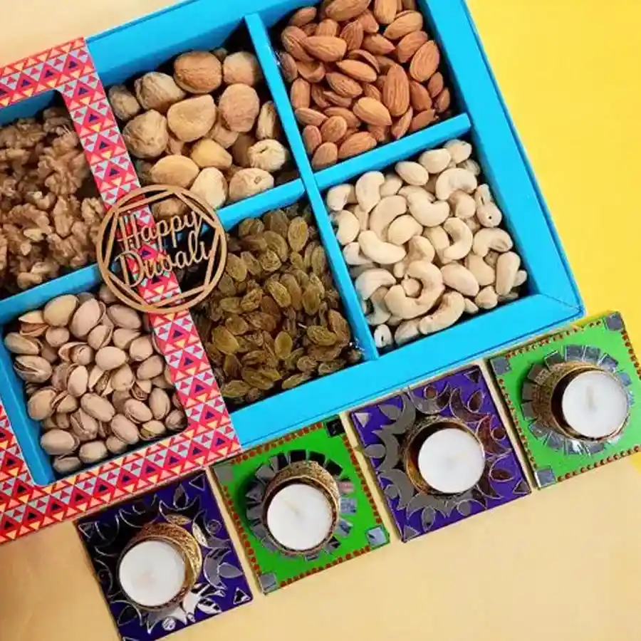 A beautifully arranged hamper containing premium nuts and designer T-light candles, elegantly presented in a gift box, perfect for Diwali celebrations.