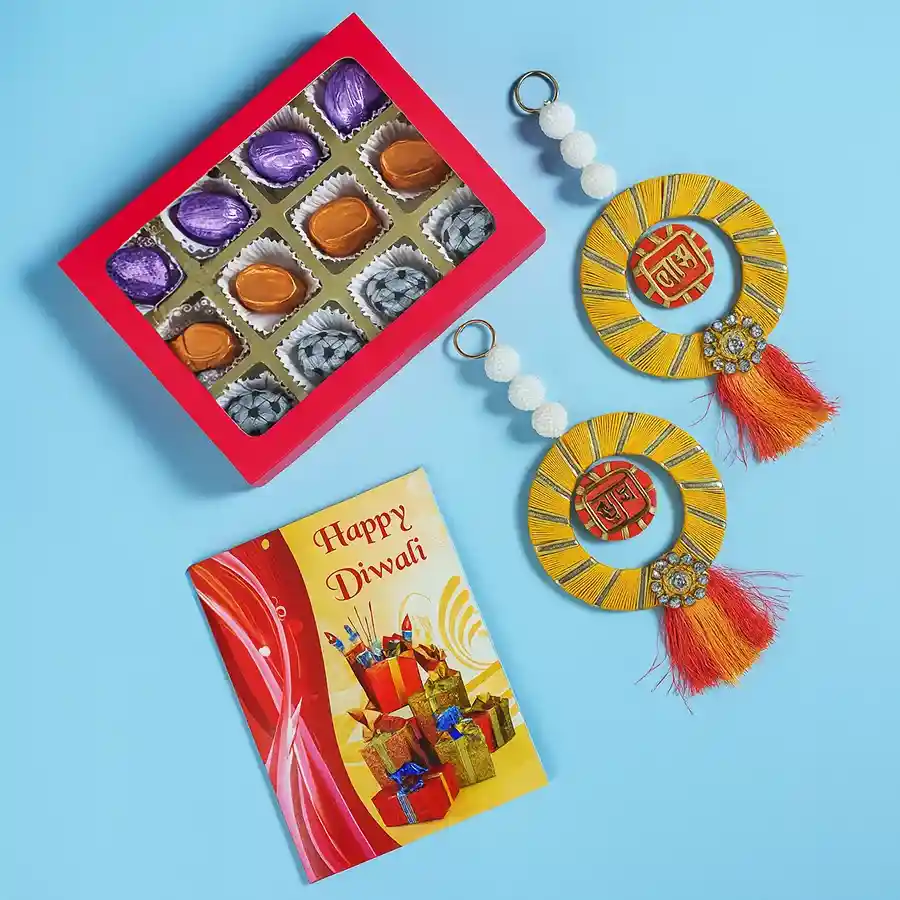 A beautifully arranged gift box containing handcrafted assorted chocolates, designer Shubh Laabh hangings, and a Happy Diwali card, ideal for celebrating Diwali.
