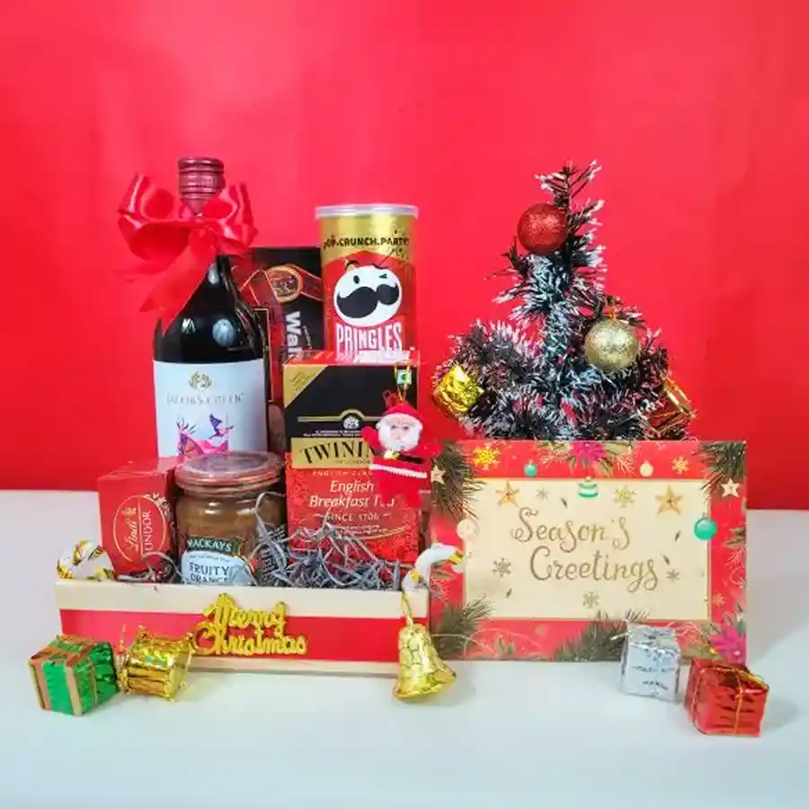 Festive Flavour Fusion Hamper featuring a variety of holiday treats including non-alcoholic Shiraz, crisps, marmalade, shortbread, chocolates, tea, and festive decorations in an elegant basket.