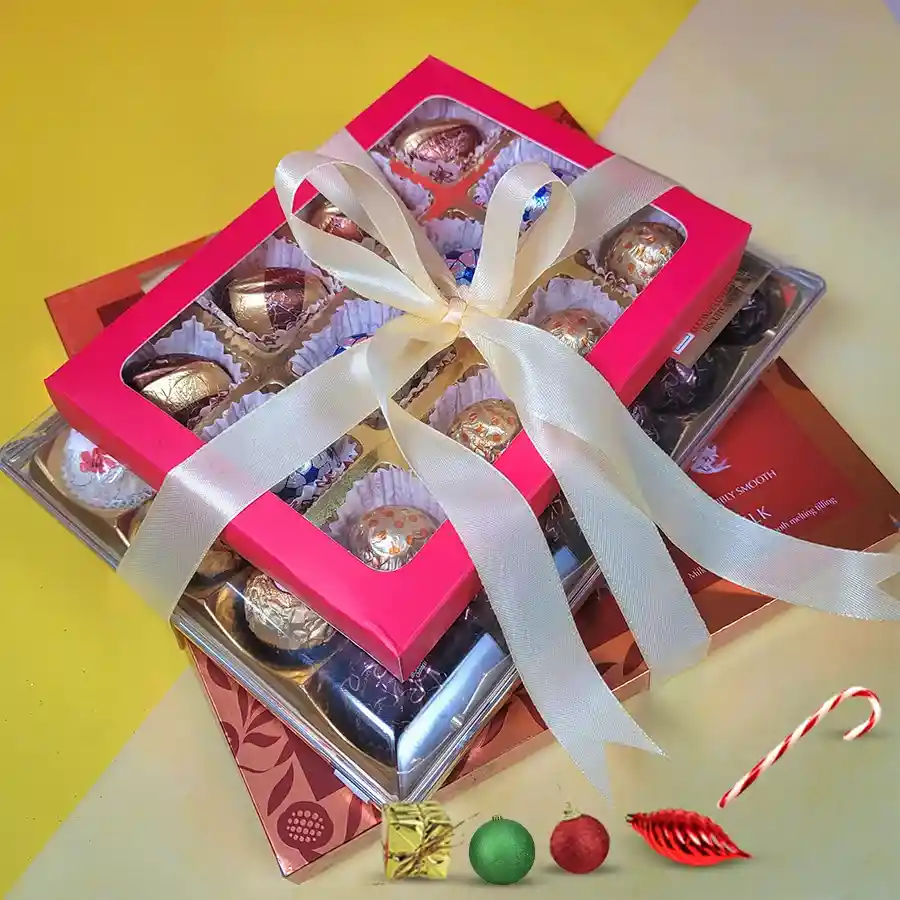 Chocolate Bliss Bonanza gift tower featuring Lindt Lindor Milk Chocolate, Ferrero Rocher collection, and handcrafted artisan chocolates, elegantly wrapped with a ribbon.