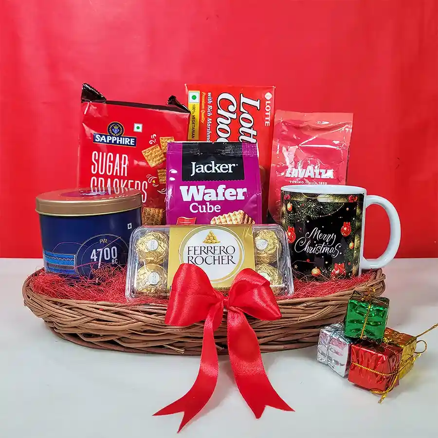X-Mas Enchantment Basket filled with treats like Sapphire Sugar Crackers, Lotte Choco Pies, Lavazza coffee, Jacker Wafer Cubes, Himalayan sea salt popcorn, Ferrero Rocher chocolates, a festive coffee mug, and Christmas decorations, beautifully wrapped in a decorative chest or basket.