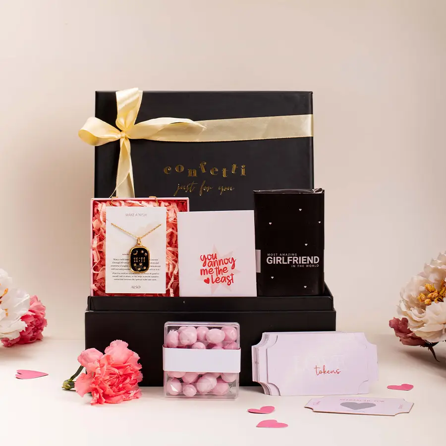 Tokens of Love Gift Hamper for Her featuring chocolates, a necklace, strawberry dragees, and love tokens in a chic black box.