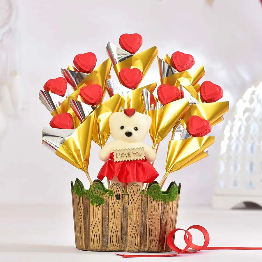 Romantic Choco Temptation Arrangement with handmade chocolates in a wooden pot and a Valentine's card.