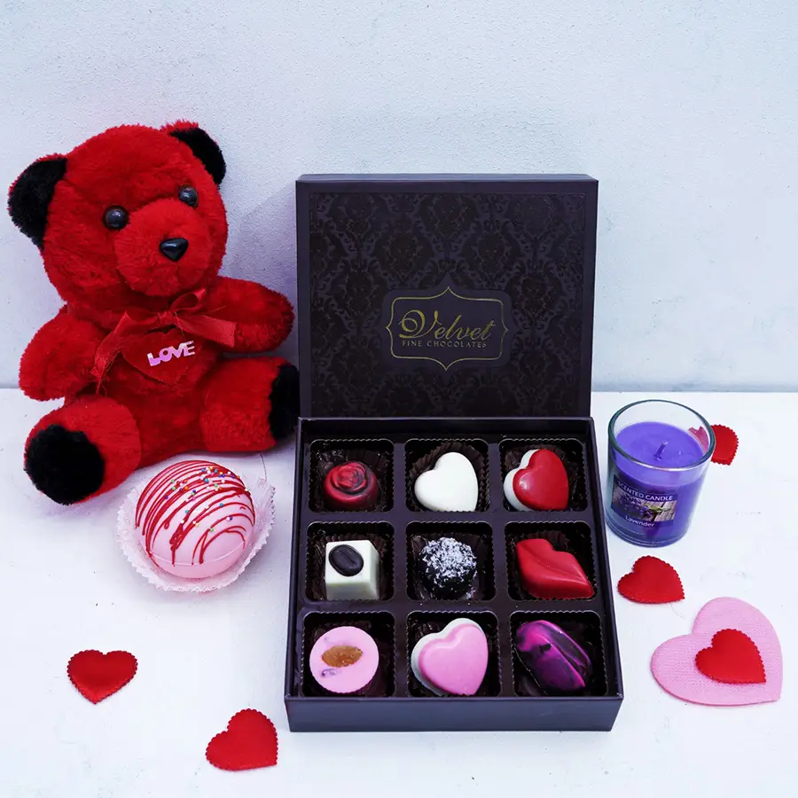 Love N Luxuries Gift Box for Her filled with chocolates, a hot chocolate bomb, a scented candle, and a teddy bear