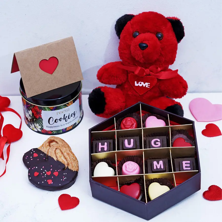Blissful Chocolates Cookies N Teddy Hamper featuring assorted chocolates, palmiers cookies in a tin, a love card, and a teddy bear