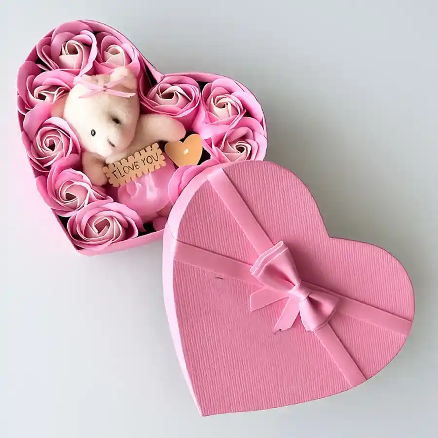 Heart-shaped box with fresh roses and a teddy bear inside