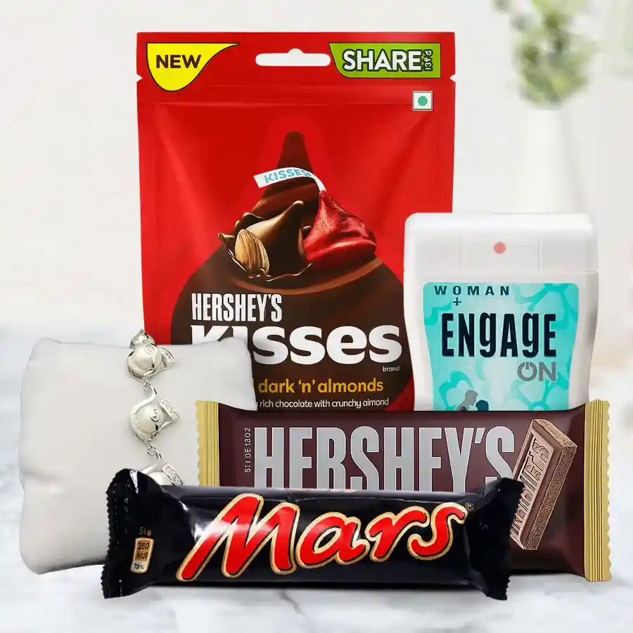 Chocolate Indulgence N Fragrant Twist Gift Set featuring a Mars bar, Hershey’s Special Dark and Almond Kisses, Hershey Milk Bar, stylish bracelet, and Engage pocket perfume arranged in an elegant presentation.