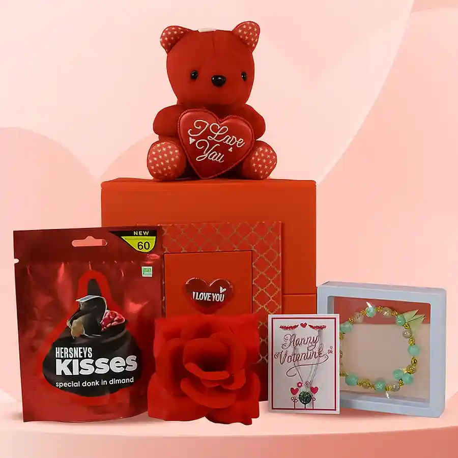 Valentine's gift set featuring a red box with a bracelet, necklace, teddy bear, fresh rose, and chocolates