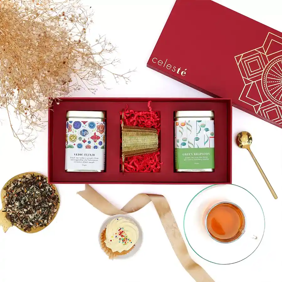 Ultimate Tea Infusion Gift Set with Vedic Elixir Tea, Green Rhapsody Tea, and a handwoven brass basket strainer in an elegant presentation.