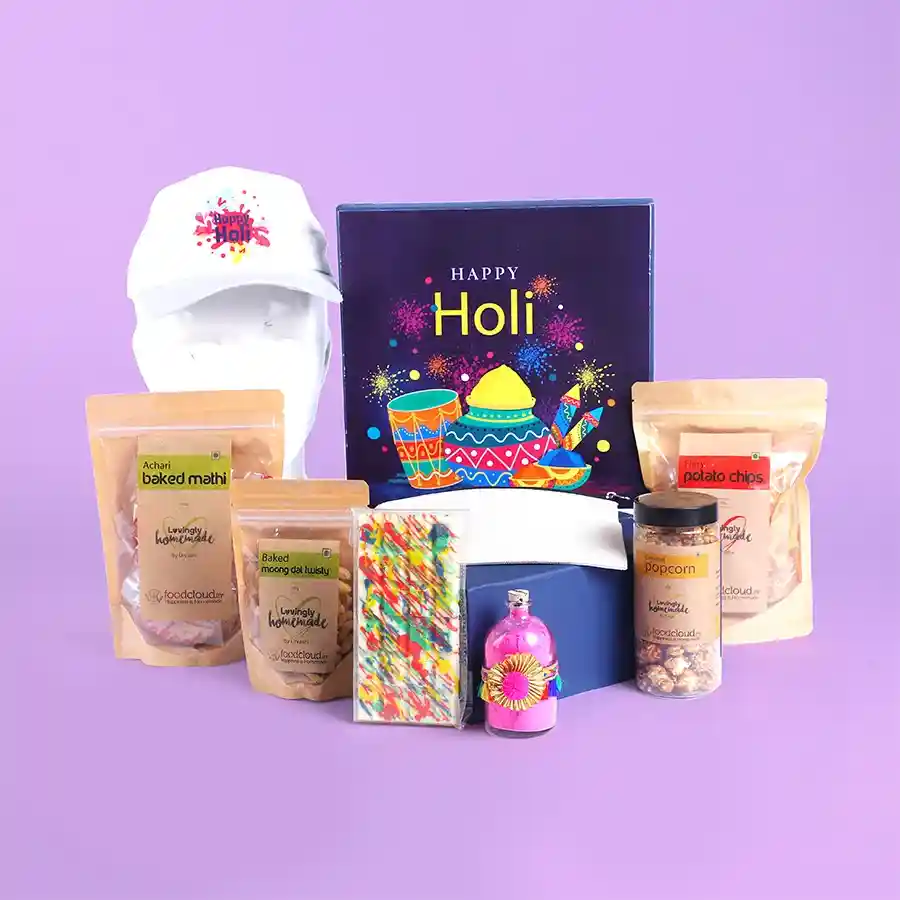 Vibrant Holi Gift Hamper featuring colorful snacks, organic gulal jar, Holi cap, and vanity pouch