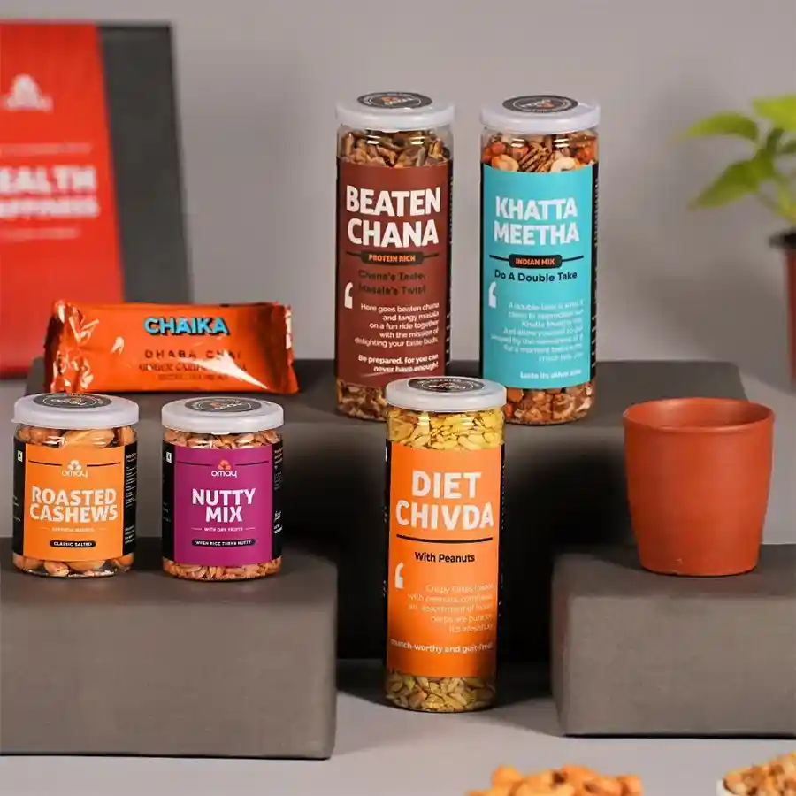 Wholesome Mother's Day Delight Gift Box featuring Beaten Chana, Khatta Meetha, saffron-infused roasted cashews, Diet Chivda, nutty mix with dry fruits, Chaika Instant Tea in a ceramic Kulhad, and a Mother's Day greeting card, all beautifully arranged in a special gift box.
