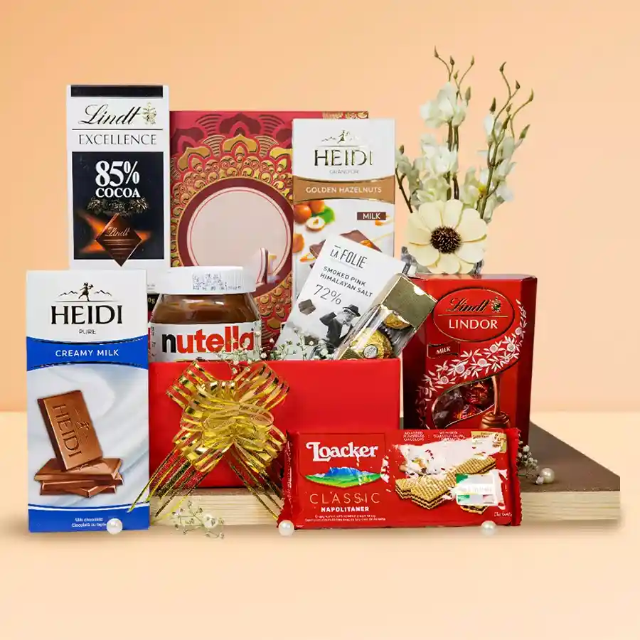 Luxurious chocolate treat hamper filled with Nutella, Lindt chocolates, Heidi bars, Loacker wafers, La Folie Himalayan Salt chocolate, and Ferrero Rocher, arranged in a reusable basket.