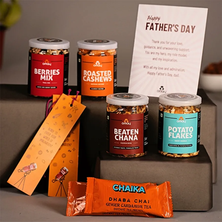Premium Treats N Surprises Gift Hamper for Dad featuring snacks, tea, bookmarks, and a greetings card