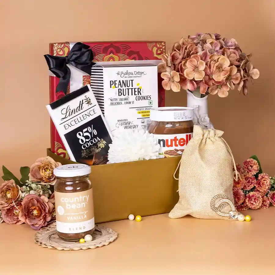 Nutella N Artisan Snacks Gift Basket with Nutella Spread, Lindt dark chocolate, premium cashews and almonds, peanut butter cookies, and Country Bean Coffee in a jute potli