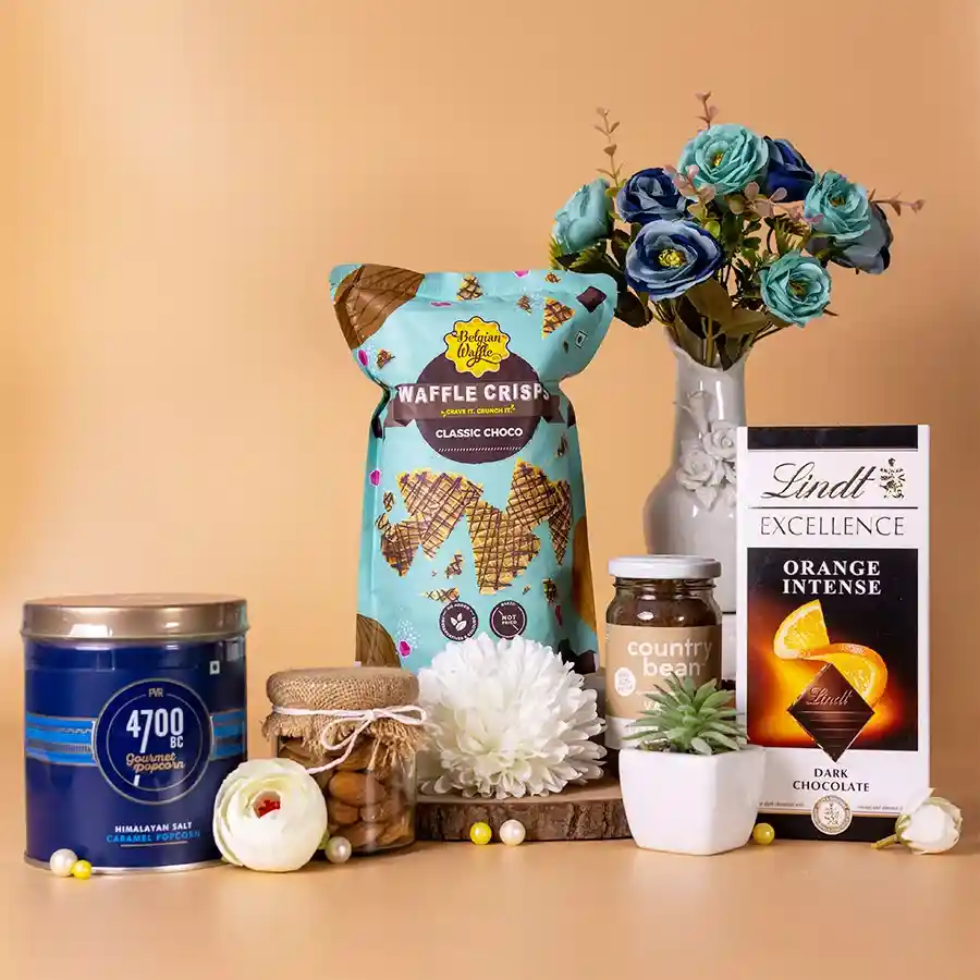 Exquisite Almond N Gourmet Treats Hamper featuring popcorn, dark chocolate, almonds, waffle crisps, and coffee