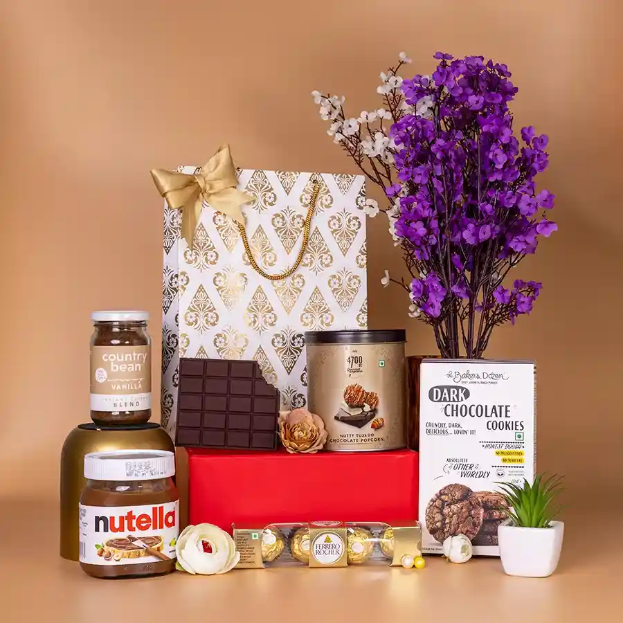 Deluxe Nutella N Gourmet Treats Gift Hamper featuring Nutella Spread, dark chocolate cookies, popcorn, country bean coffee, Ferrero Rocher chocolates, and a chocolate-shaped notepad in a stylish gift bag.