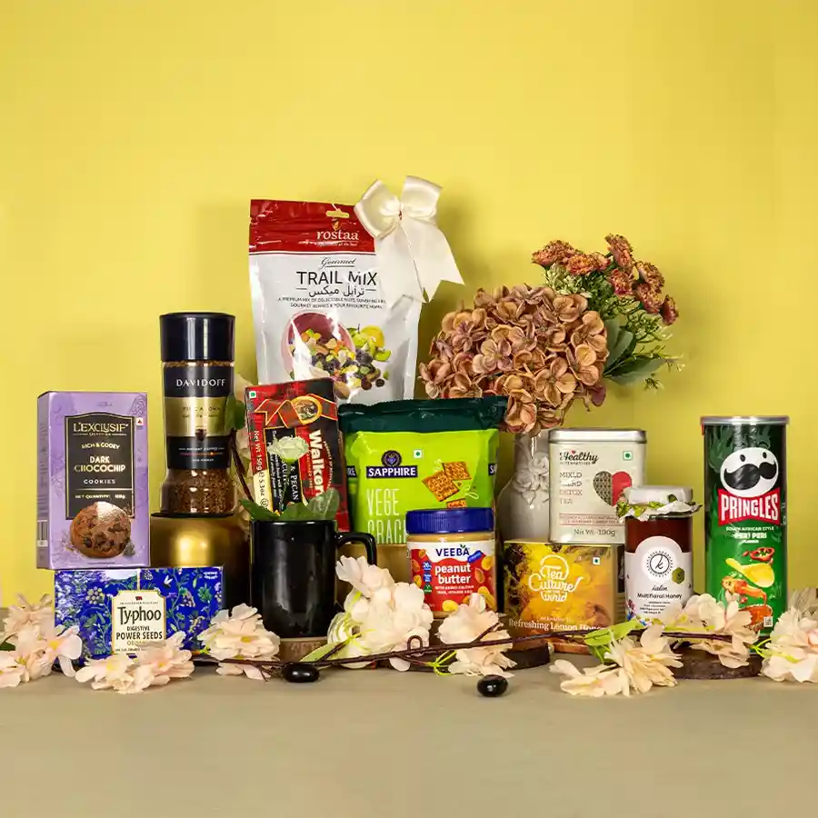 Premium Snacks N Sip Gift Set featuring assorted gourmet snacks, beverages, and a stylish black coffee mug.