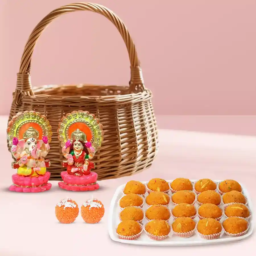 Laxmi and Ganesh murtis with Ghee Laddu and candles in a reusable basket