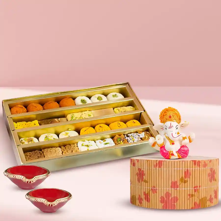 Divine Blessings n Sweet Delights Set featuring a Marble Abhaya Mudra Ganesha, assorted mix sweets, and two elegant Mud Diyas.
