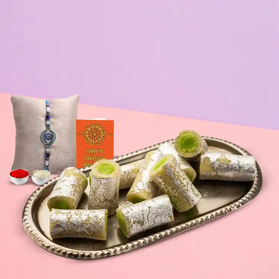 Tasty Kaju Pista Roll with a fancy Rakhi and free Roli Tilak Chawal pack for Raksha Bandhan celebration