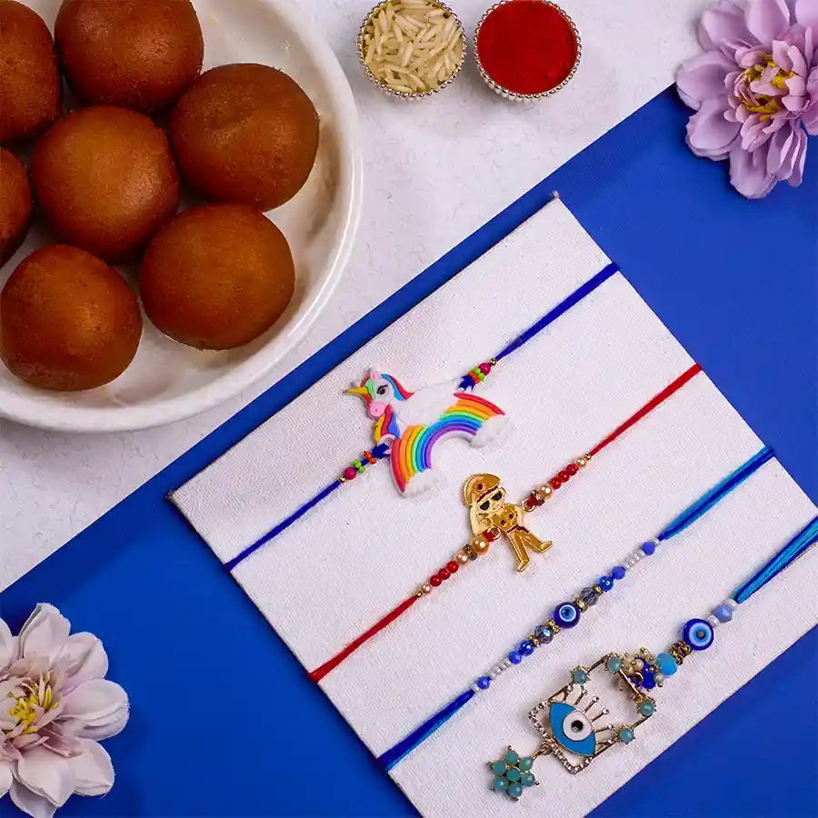Trendy Family Rakhi Set with Evil Eye Bhaiya Bhabhi Rakhi, kids' rakhis, and Gulab Jamun combo with festive accessories.