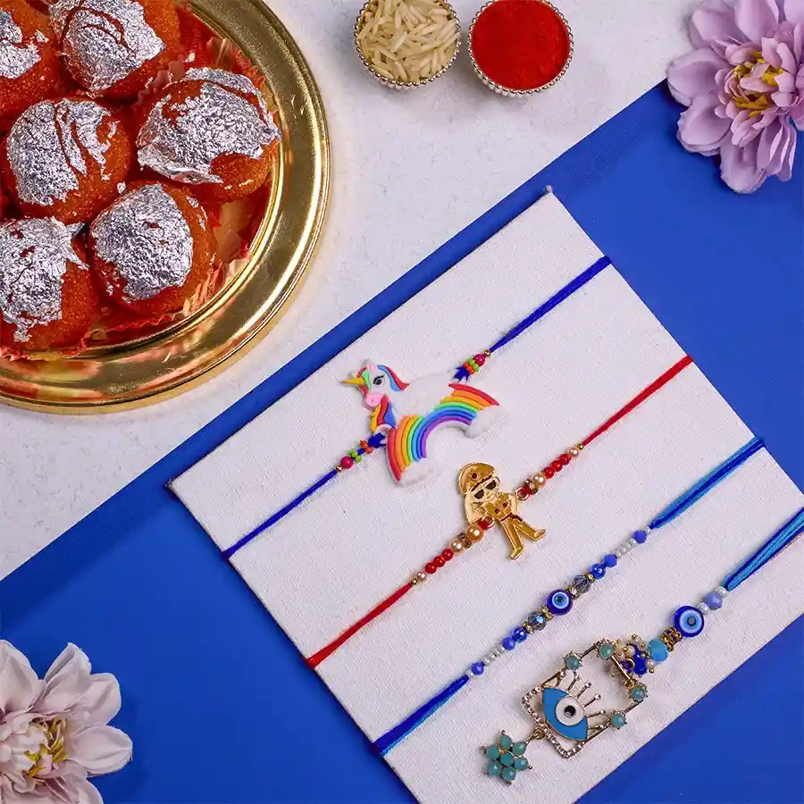 Elegant Family Rakhi Set with Evil Eye Bhaiya Bhabhi Rakhi, Little Singham and Unicorn Rakhis, 500g of Ghee Laddus, and complimentary Roli, Tika, Chawal, and personalized message card.