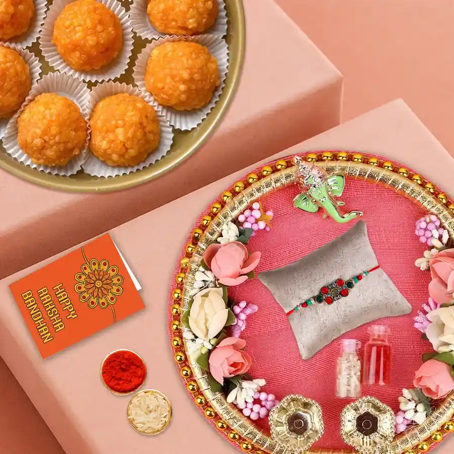Unique Rakhi Thali with multicolored Rakhi, Roli, Tilak, Chawal, and Haldiram Laddoos