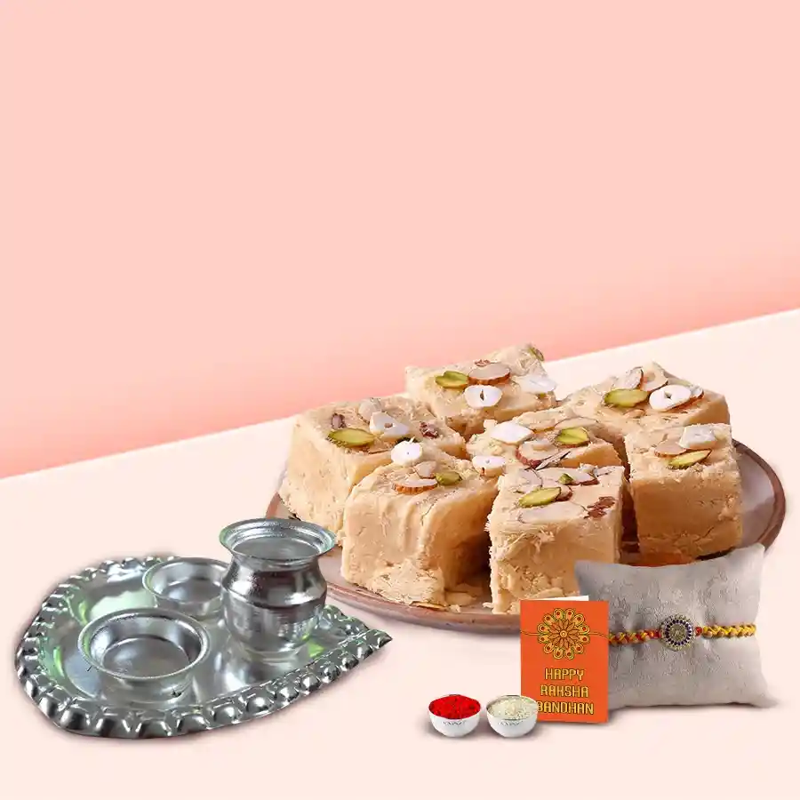 Haldiram Soan Papri pack, silver-plated paan-shaped Puja Aarti Thali, Rakhi, Roli Tilak, Chawal, and personalized message card arranged on a festive background.