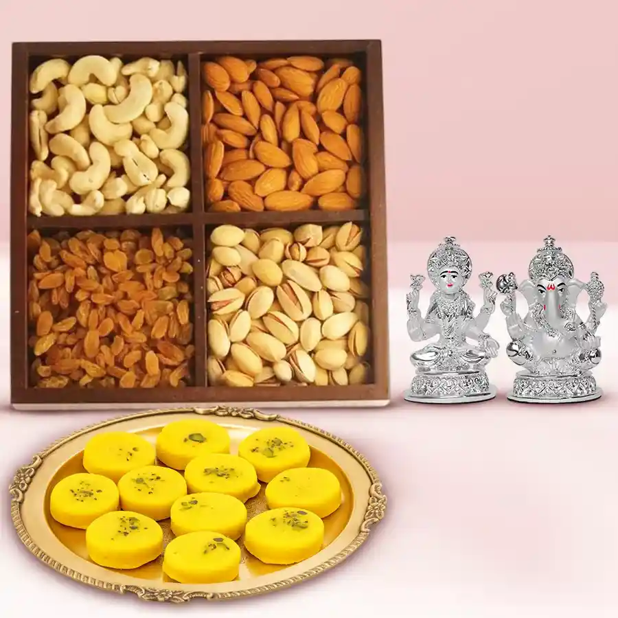 Dry fruits assortment, Haldirams Kesaria Peda, and a silver-plated Ganesh Lakshmi idol in a festive gift set.