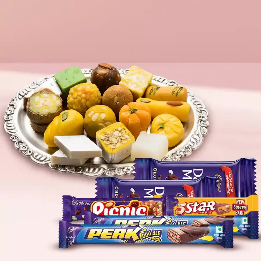 Assorted Haldirams sweets in a box alongside Cadbury chocolates, beautifully arranged