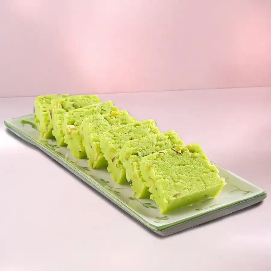 Special Haldirams Mawa Pista Barfi in a decorative packaging, showcasing the rich texture and colorful presentation of the sweet treat