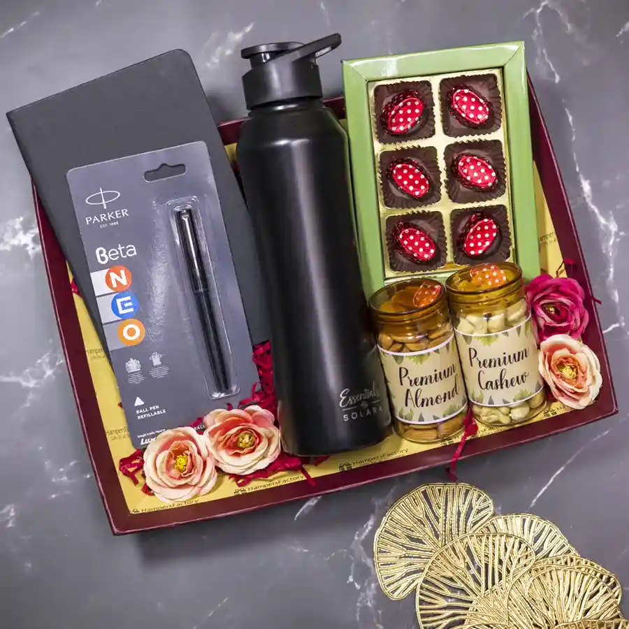 Sweet N Stylish Gift Bundle featuring homemade chocolates, premium almonds and cashews, a black sipper bottle, a black notebook, and a Parker Beta pen arranged in a reusable designer tray.