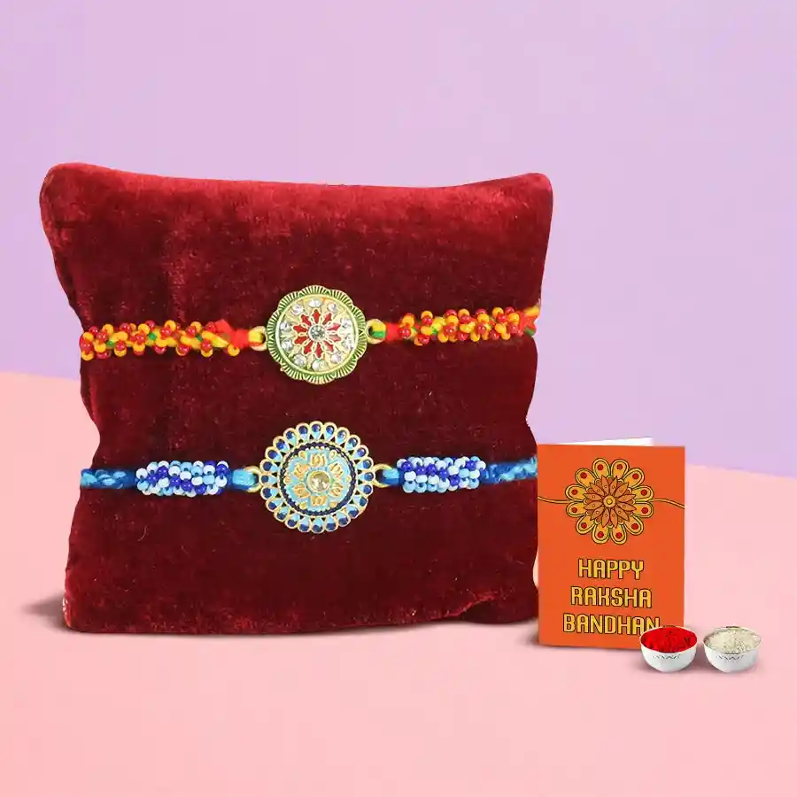 Two beautifully crafted Rakhis with Roli Chawal in an elegant setting for Raksha Bandhan celebration.