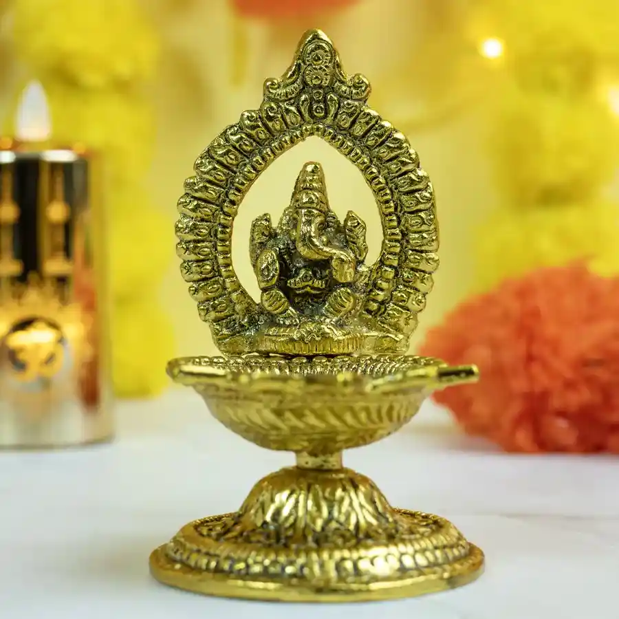 Traditional Brass Ganesha Diya oil lamp showcasing intricate details and warm glow