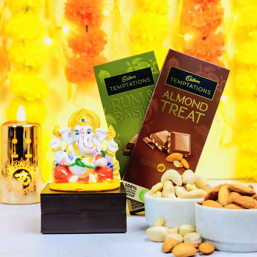 Spiritual Ganesha idol beside a selection of choco nut treats including Cadbury Temptations Rum N Raisins, almond treats, almonds, and cashews on a decorative background.