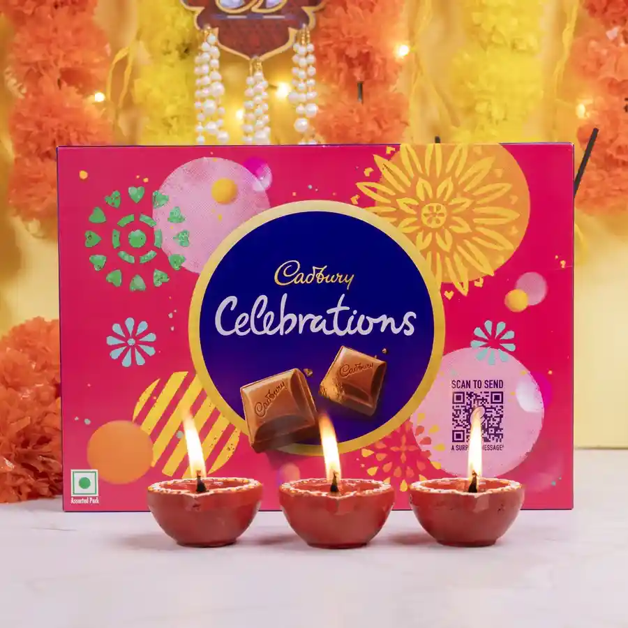 Choco Delight N Diya Set featuring Cadbury Celebrations chocolate pack and three mud diyas on a festive background