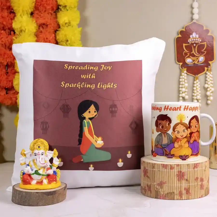 Sparkling Light Gift Collection featuring a cozy cushion, a heart-themed mug, and a marble Ganesha statue arranged beautifully