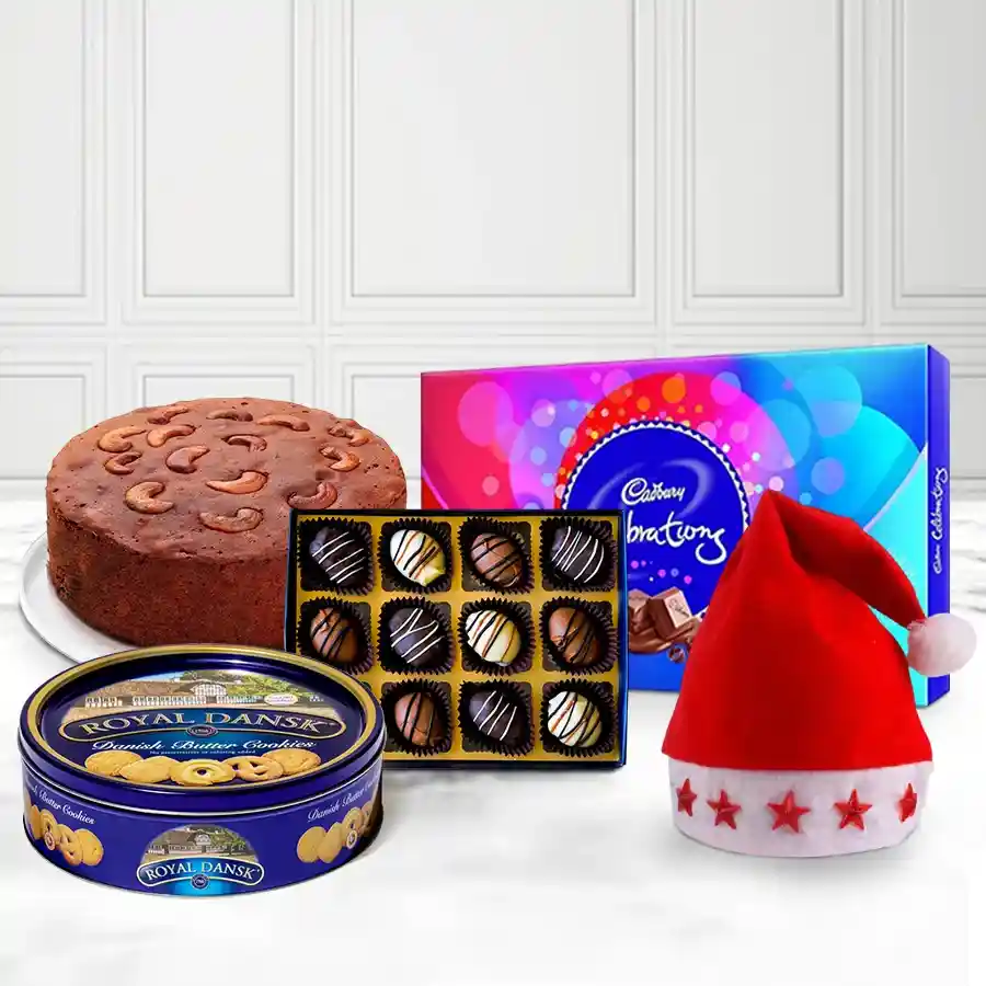 Dreamy Christmas Arrangement featuring a Santa lighted cap, Cadbury Celebration Pack, handmade chocolates, Danish cookies, and a one-pound Christmas cake, all beautifully arranged for the holiday season.