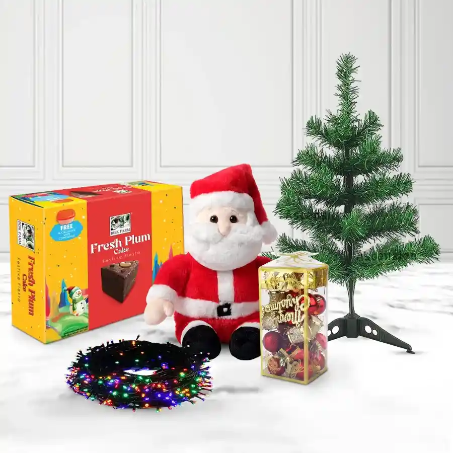 Ravishing Collection of Christmas Delicacies featuring a 1-foot Christmas tree, Santa Claus soft toy, LED decorations, and Bisk Farm Cake arranged beautifully for the holiday season.